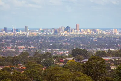 Adelaide city skyline viewed from the hills, showing the urban sprawl and coastline of a city whose tap water quality differs significantly from Melbourne