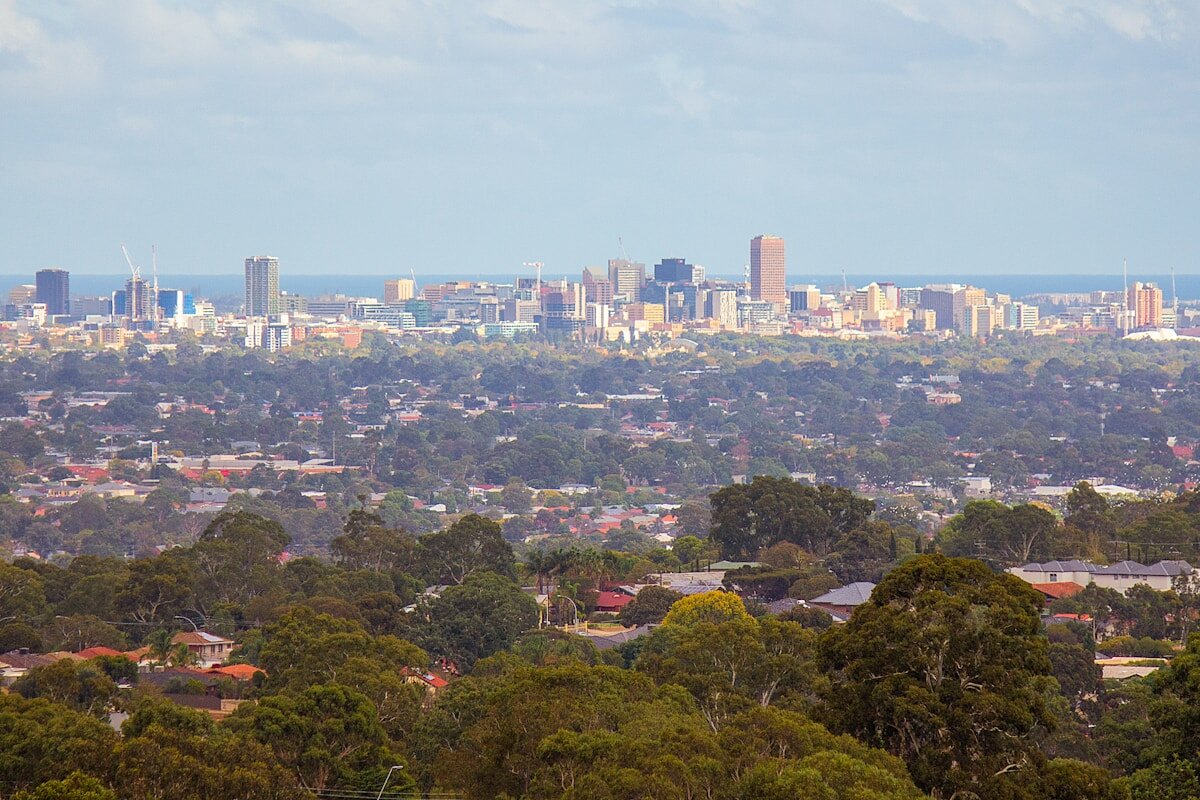 Adelaide city skyline viewed from the hills, showing the urban sprawl and coastline of a city whose tap water quality differs significantly from Melbourne
