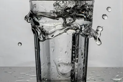 Clear glass of tap water on a kitchen bench in an Australian home, representing the best water quality suburbs in Australia