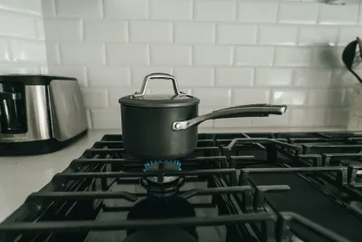 Kettle boiling on a kitchen stovetop with steam rising, representing whether boiling water removes chlorine and fluoride