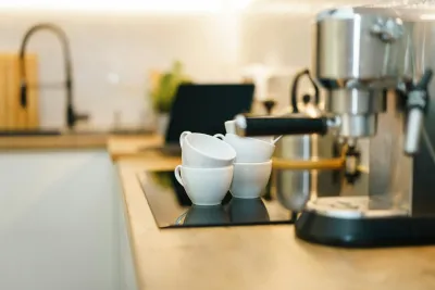 Home espresso machine on a kitchen bench beside the tap, the setup to check before deciding how often to descale a coffee machine