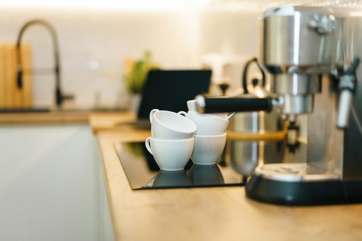 Home espresso machine on a kitchen bench beside the tap, the setup to check before deciding how often to descale a coffee machine