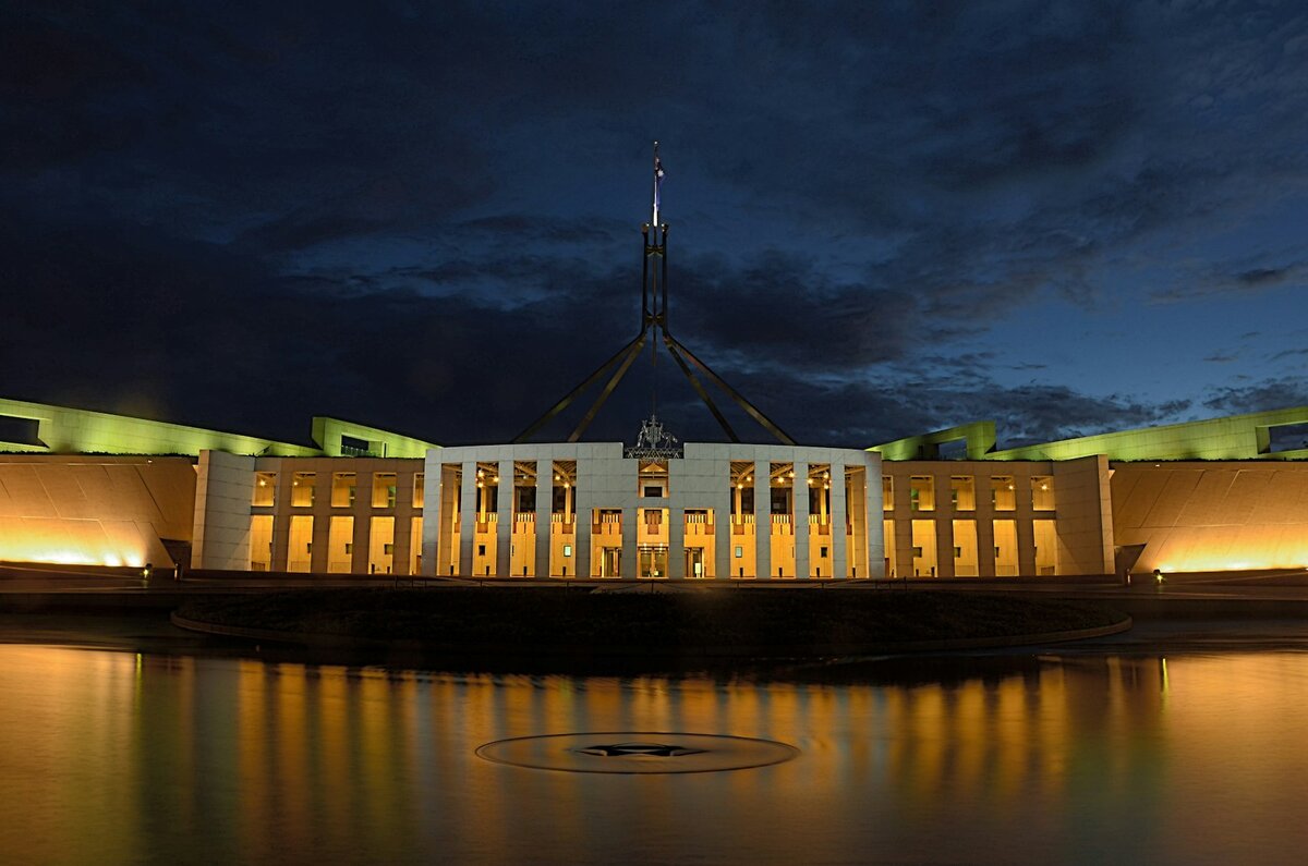 Australian Parliament House in Canberra beside Lake Burley Griffin, the city served by Icon Water's tap water supply