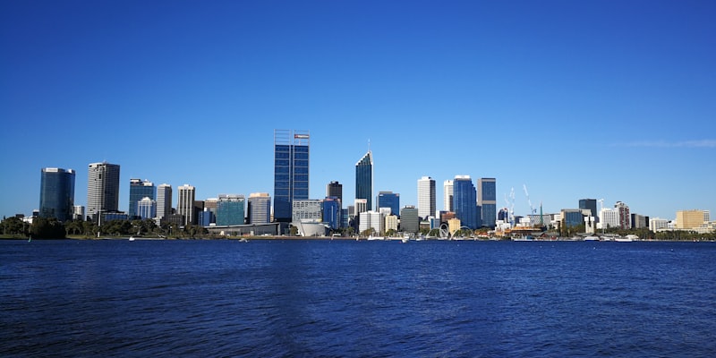 Perth and Adelaide city skylines representing two Australian cities known for their harder tap water compared to the eastern capitals