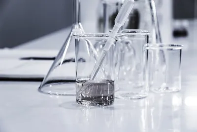 Laboratory beakers and pipette with water samples being tested for PFAS contamination in Australian water