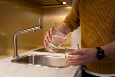 Glass being filled at a Melbourne kitchen tap, the starting point for choosing a water filter in Melbourne
