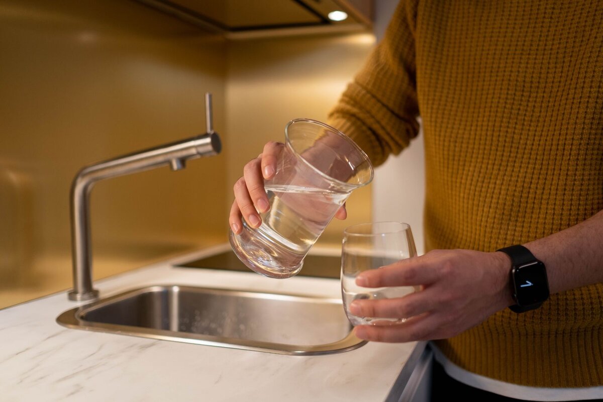 Glass being filled at a Melbourne kitchen tap, the starting point for choosing a water filter in Melbourne