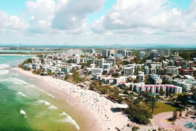 Aerial view of Kings Beach in Caloundra with the Glass House Mountains behind, part of the Sunshine Coast where water hardness averages about 60 mg/L