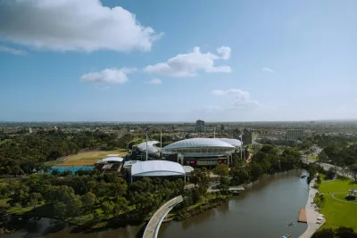 Adelaide Oval and city skyline beside the River Torrens on a sunny day, in a city where Adelaide hard water from the Murray River affects every household
